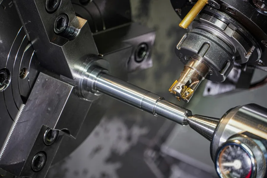 CNC lathe turning a precision steel shaft